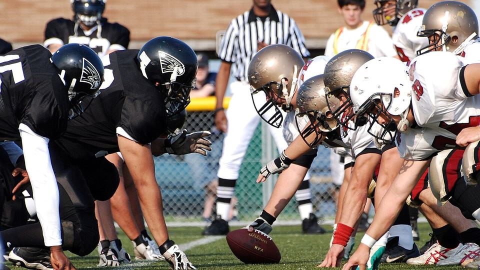 American football players at the line of scrimmage